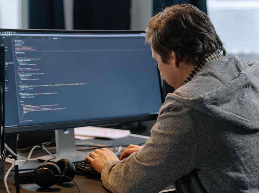 Image showing a professional working with website code to represent manufacturing SEO and technical search visibility

